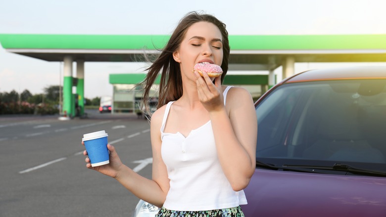 woman eating gas station donut