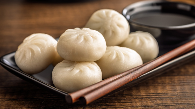 Chinese dumplings and soy sauce on a wooden table