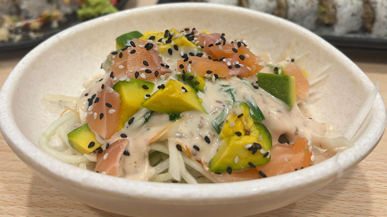 Salmon Salad and sushi rolls with sauce