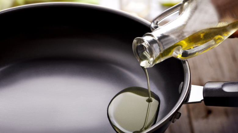 pouring oil into pan