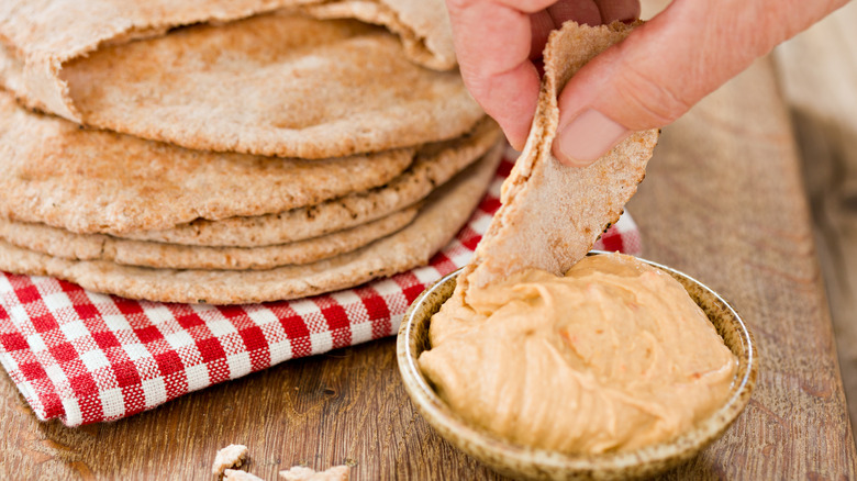 pita bread dipped in hummus