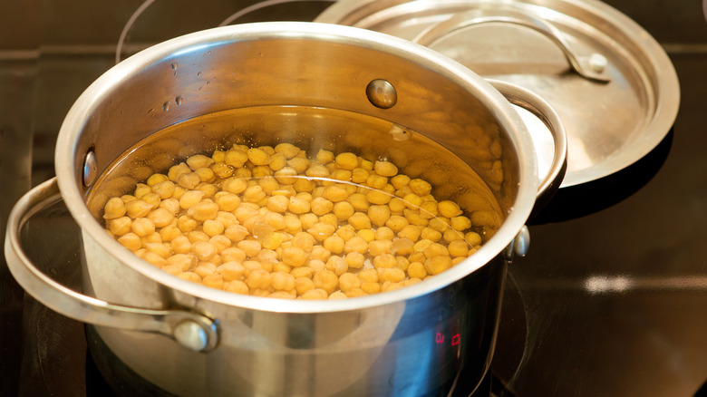 chickpeas in water in a pot on the stove