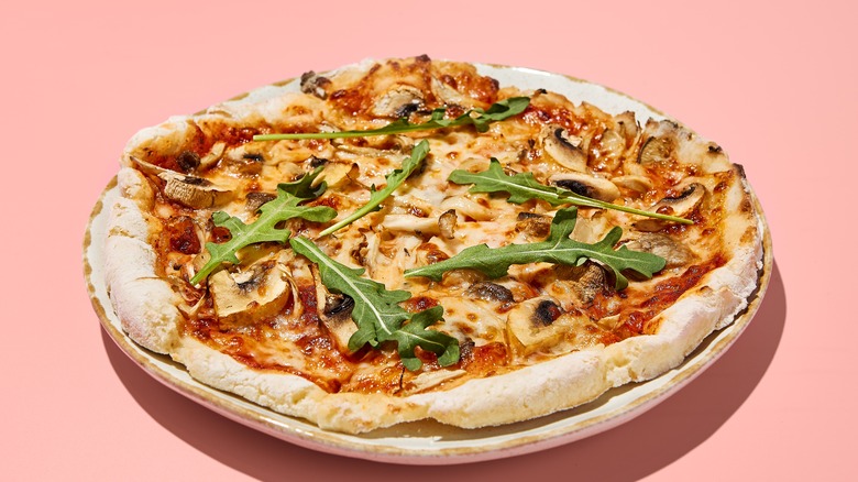 Gluten-free pizza with mushrooms and tomatoes