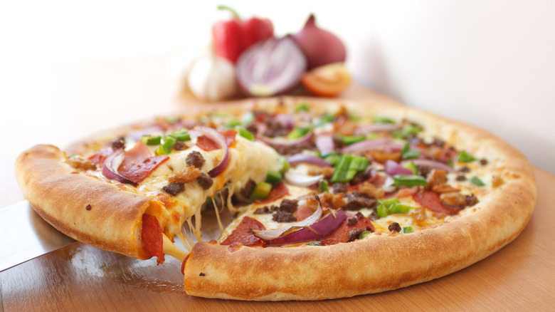 Pizza with meat and vegetable with a stuffed crust filled with pepperoni and cheese