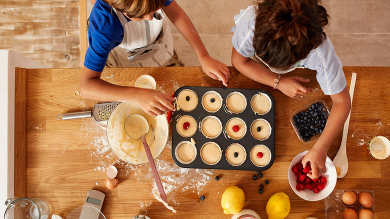 Boy and girl making muffin tin treats