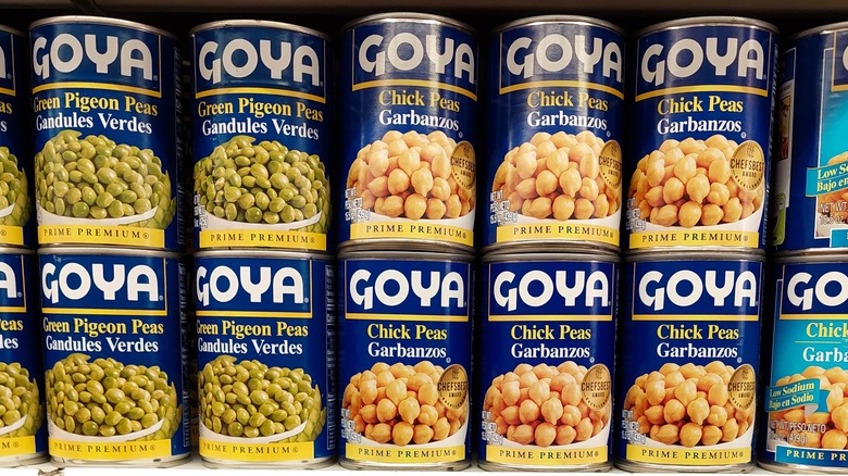 cans of Goya legumes on a supermarket shelf