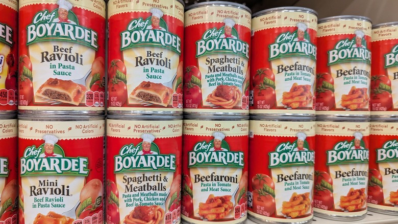 Stacks of Chef Boyardee canned pasta on a supermarket shelf