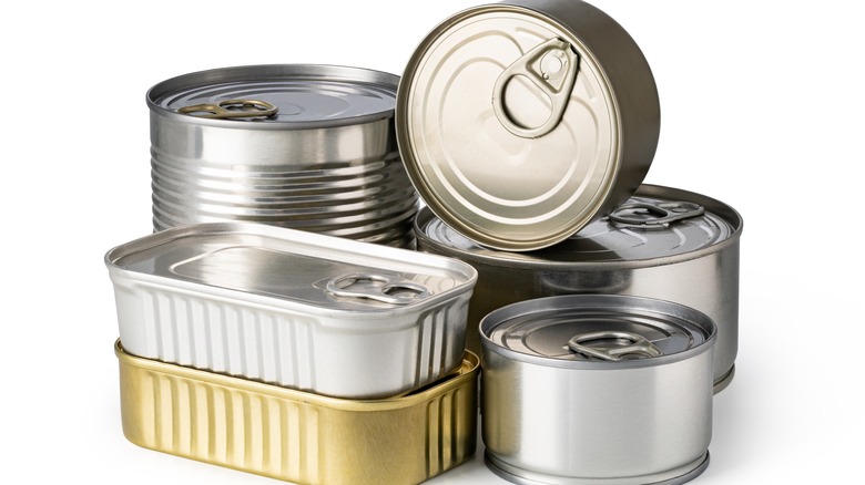 An assortment of metal cans on a white background