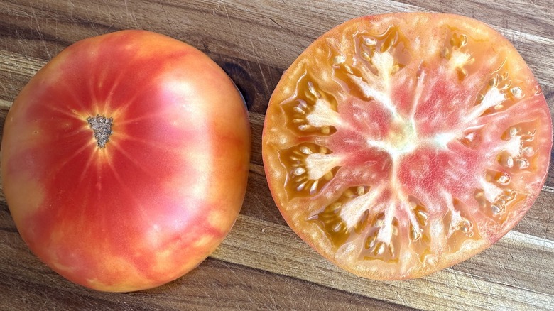 Northern Light tomatoes with one sliced open, closeup