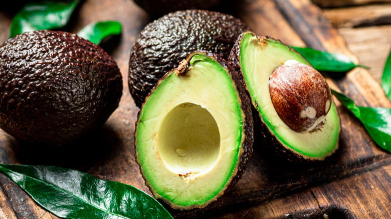 Halves of fresh avocado on a cutting board