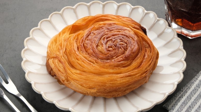 A Kouign-amann pastry on a white plate