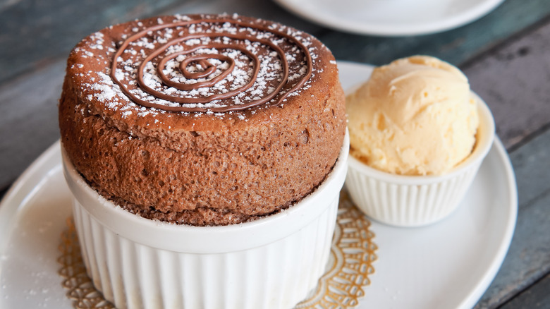 Chocolate soufflé with vanilla ice cream on white plate