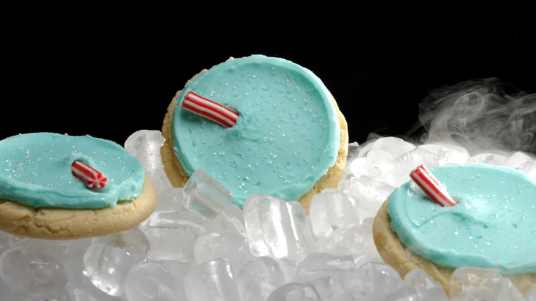 Three Blue Raspberry ft ICEE Cookies on ice on black background