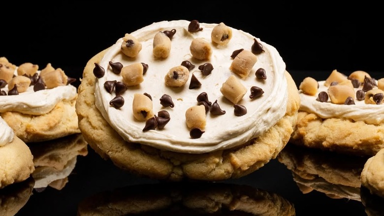Crumbl's Cookie Dough cookies on reflective black surface
