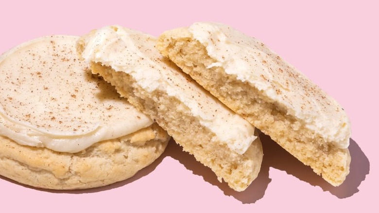 Lineup of Crumbl's Eggnog cookies on pink background
