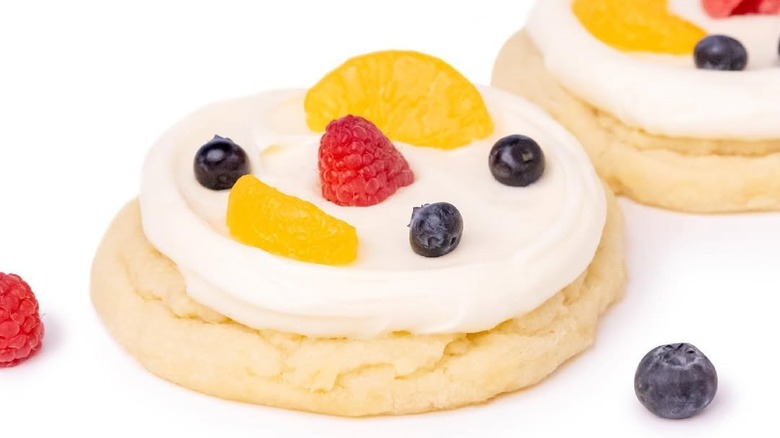 Crumbl's Fruit Pizza cookie with fresh fruit on white background