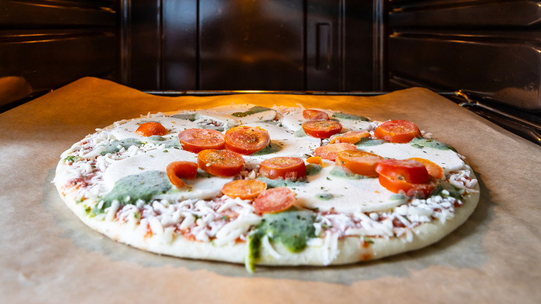 Frozen pizza baking in oven