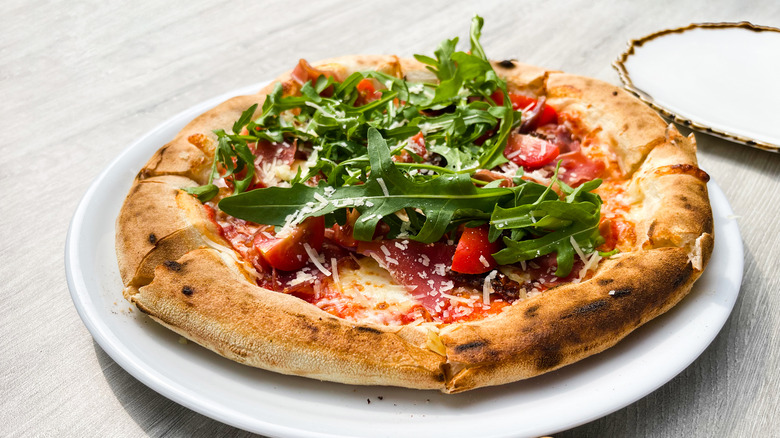 Pizza with arugula on top