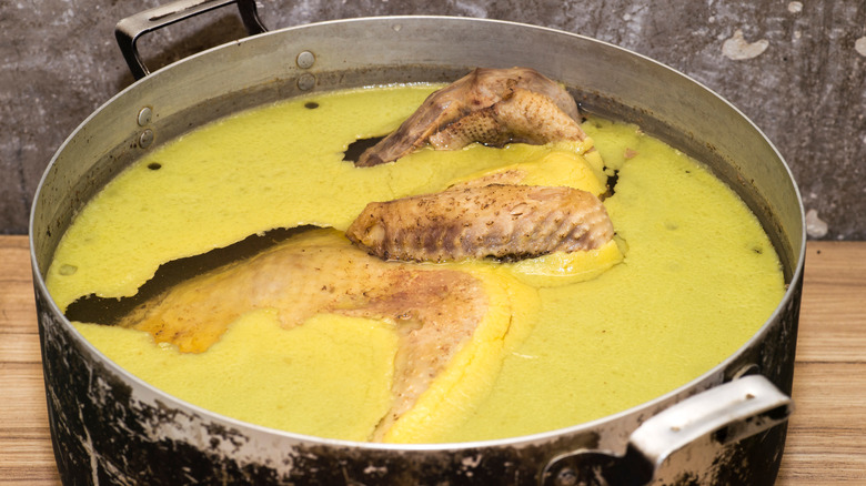 Chicken fat floating on the top of a cooking pot