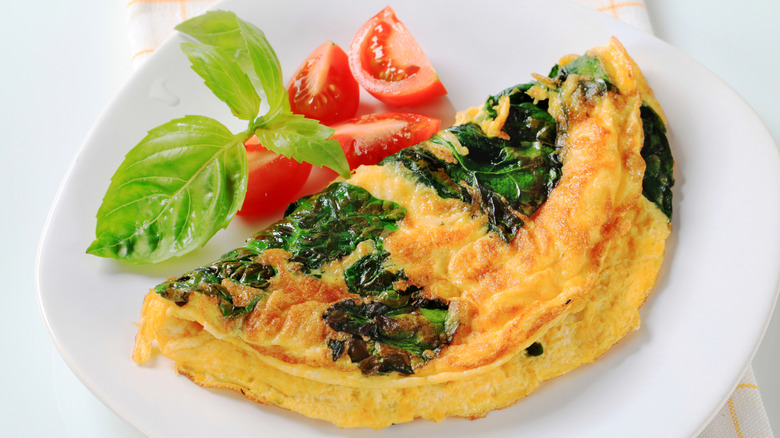 Omelet with spinach and tomatoes