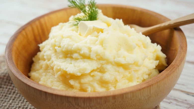 A wooden bowl of mashed potatoes