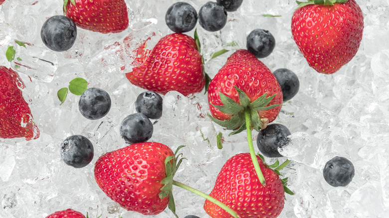 Strawberry with blueberries on ice