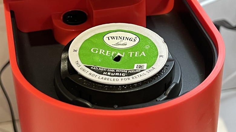 A green tea pod inside a Keurig coffee maker