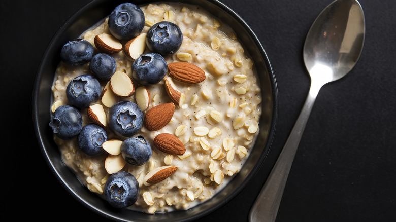 A bowl of oatmeal with blueberries and almonds