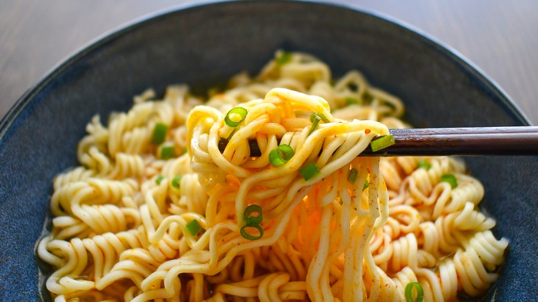 Instant noodles with chopsticks in a bowl