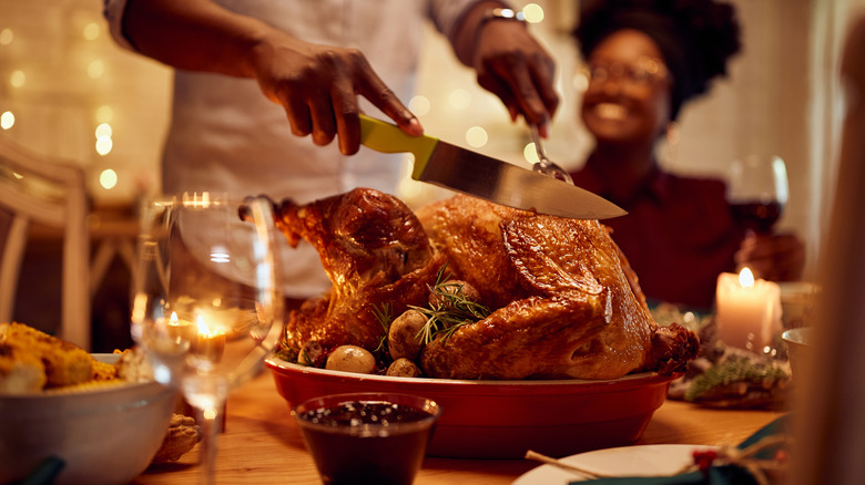 man carving turkey