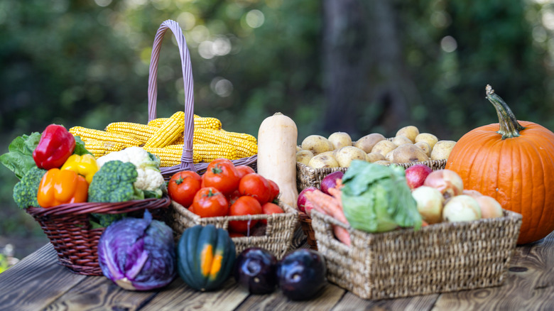 An array of fresh fruits and vegetables in wooden baskets