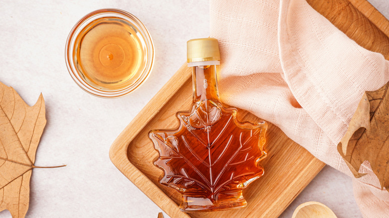 A bowl and bottle of maple syrup