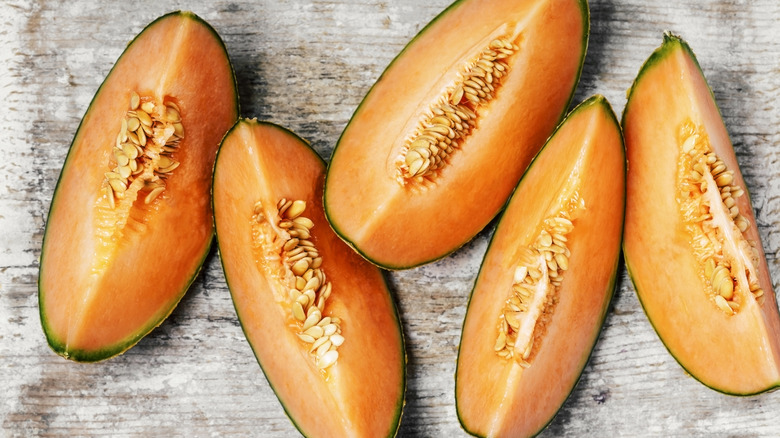 Slices of canteloupe melon on a wooden board
