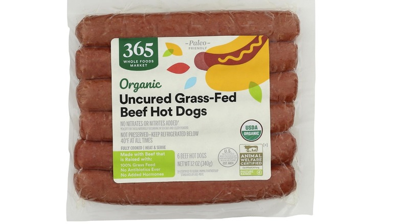 A pack of 365 Organic Uncured Grass Fed Beef Hot Dogs on a white background