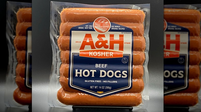 A pack of A&H Kosher Hot Dogs on a gray background