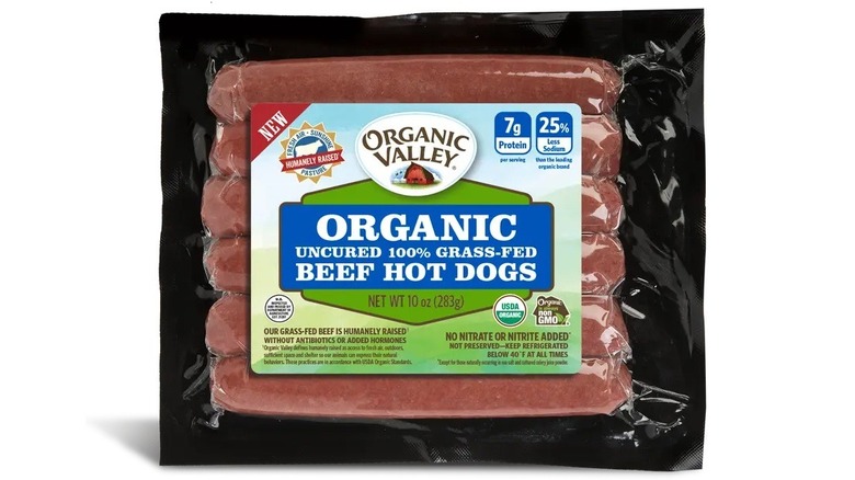 A packet of Organic Valley Organic Uncured Grass-Fed Beef Hot Dogs on a white background