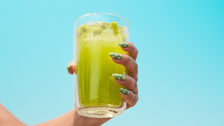 Hand grasping a glass of Starbucks Kiwi Calamansi Refresher