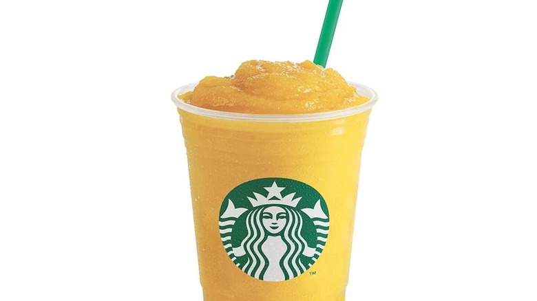 Plastic cup of Starbucks Mango Passionfruit Frappuccino with straw