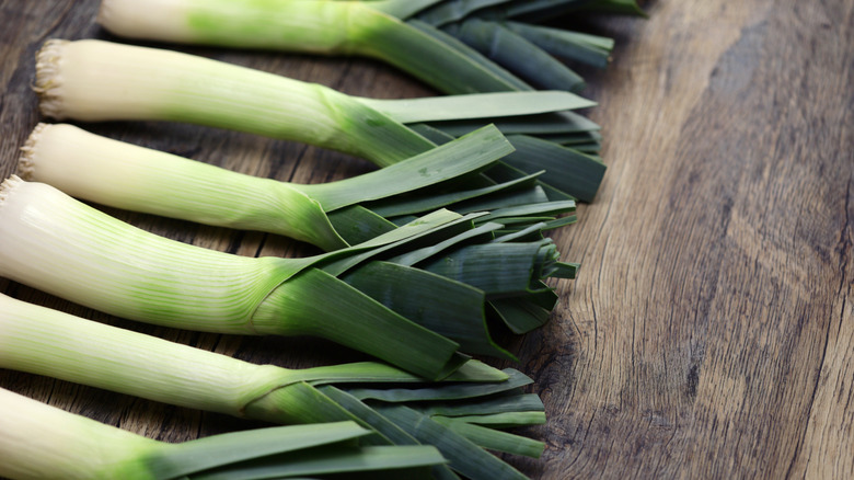 Leeks on wooden surface