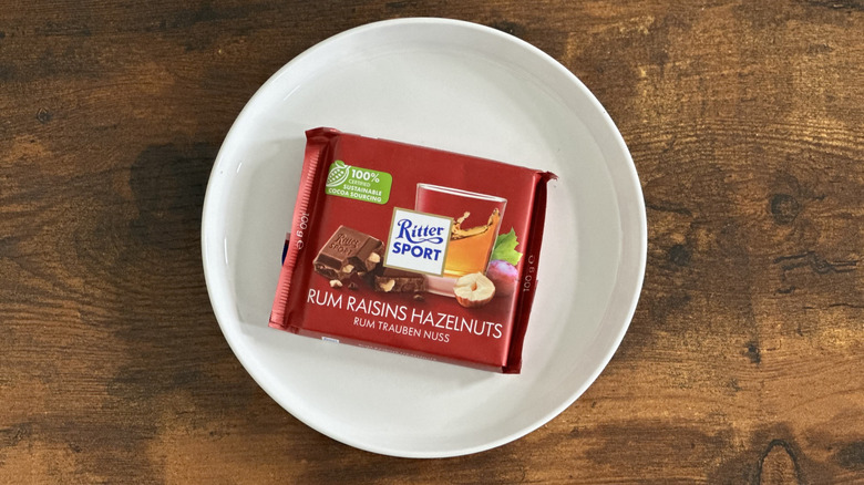 package of Ritter Sport Rum Raisins Hazelnuts on white plate on wooden table