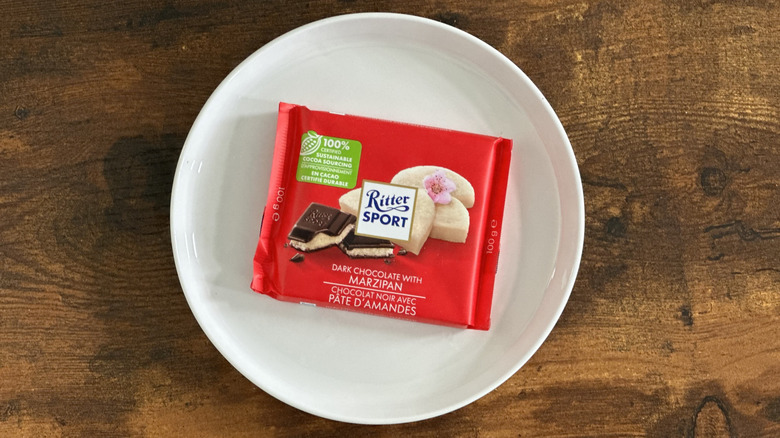package of Ritter Sport Dark Chocolate with Marzipan on white plate on wooden table