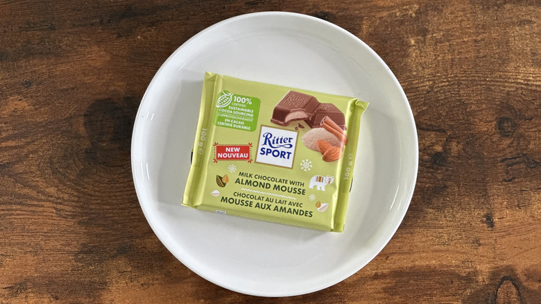 package of Ritter Sport Milk Chocolate with Almond Mousse on white plate on wooden table