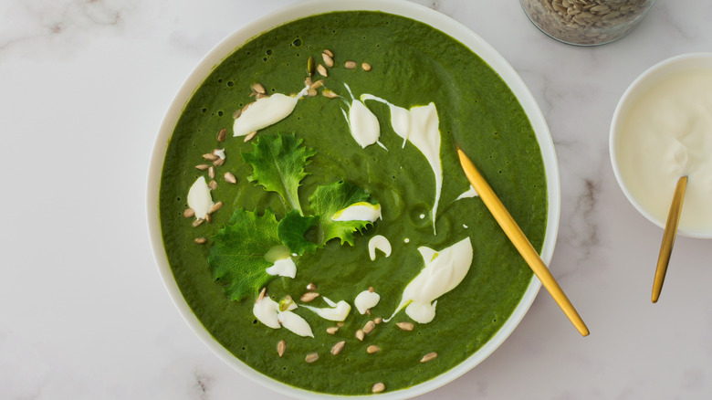 A bowl of broccoli and spinach cream soup