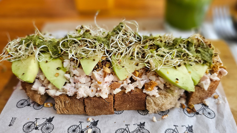 Vegan avocado toast with tofu crumble on rustic bread