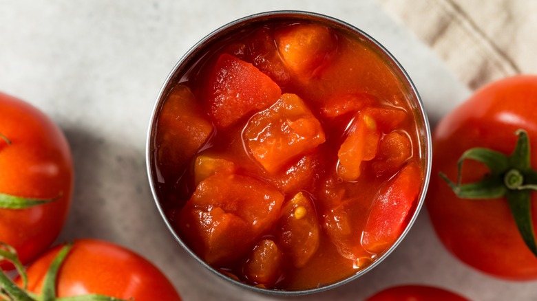 Top-down view of chopped tomatoes in a can