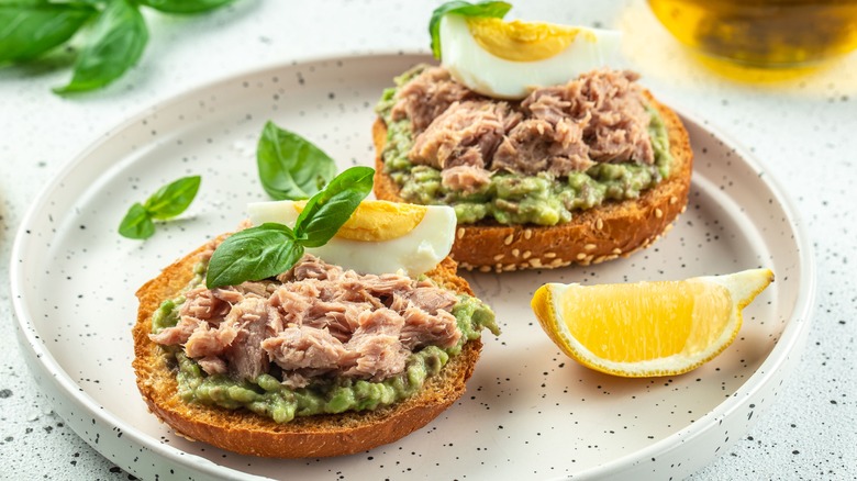 Open sandwiches with canned tuna, boiled egg and avocado