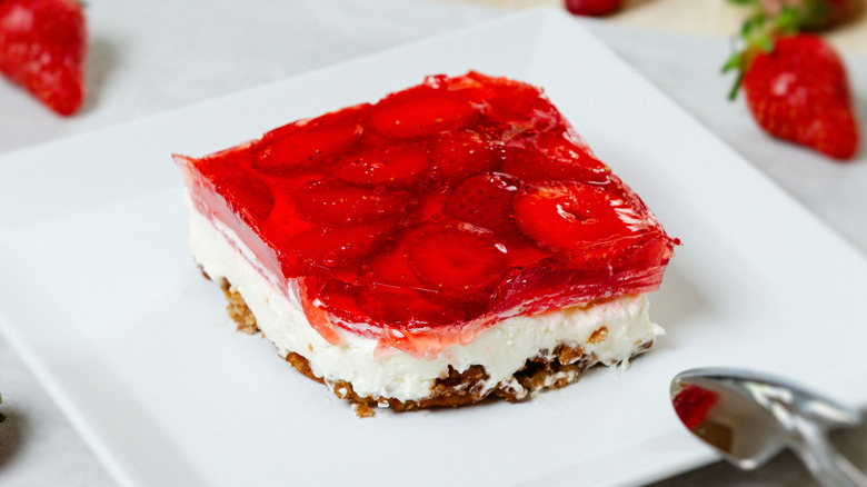 A slice of strawberry pretzel salad on a plate