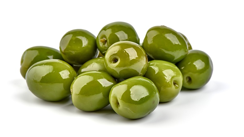 Marinated Castelvetrano green olives.Close up. Isolated on white background
