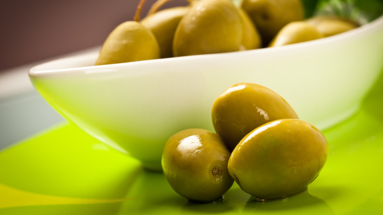 Cerignola olives in white bowl and green plate