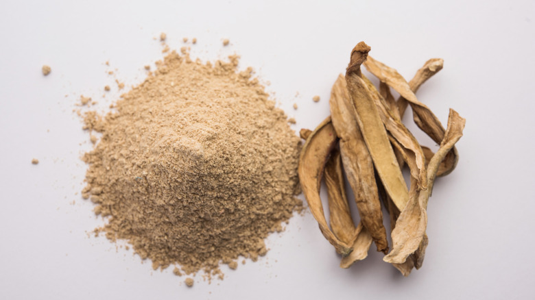 A pile of amchur next to dried mango strips